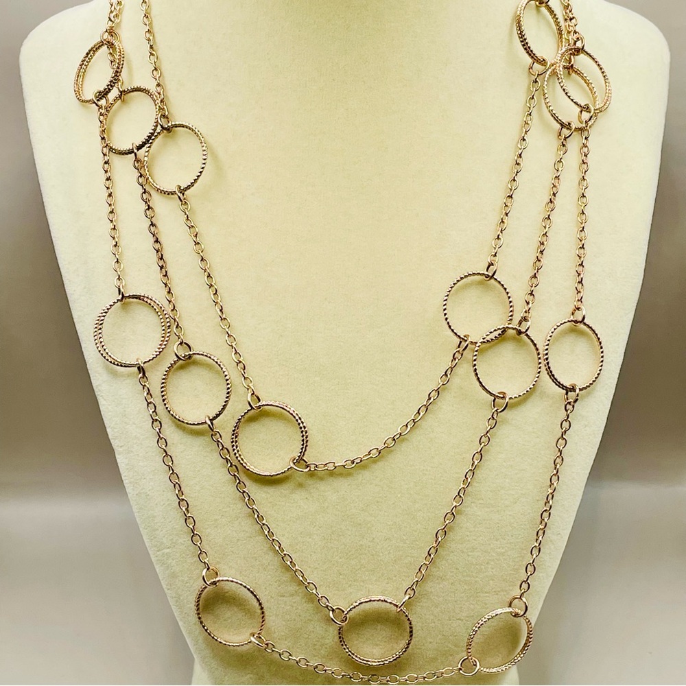 60 inch long copper tone circle station necklace. Can be doubled or tripled.